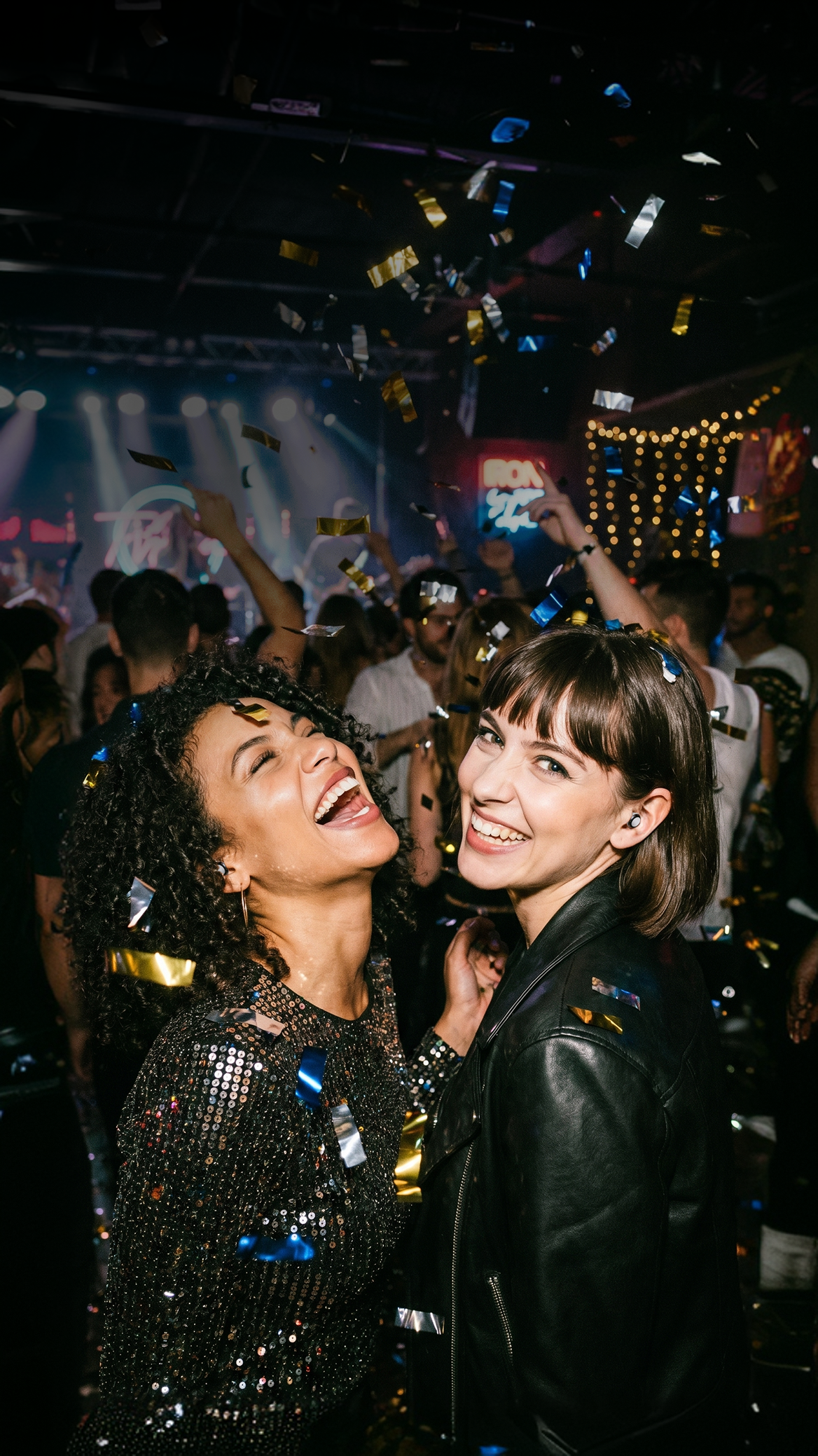 Two women celebrating with confetti at a party.